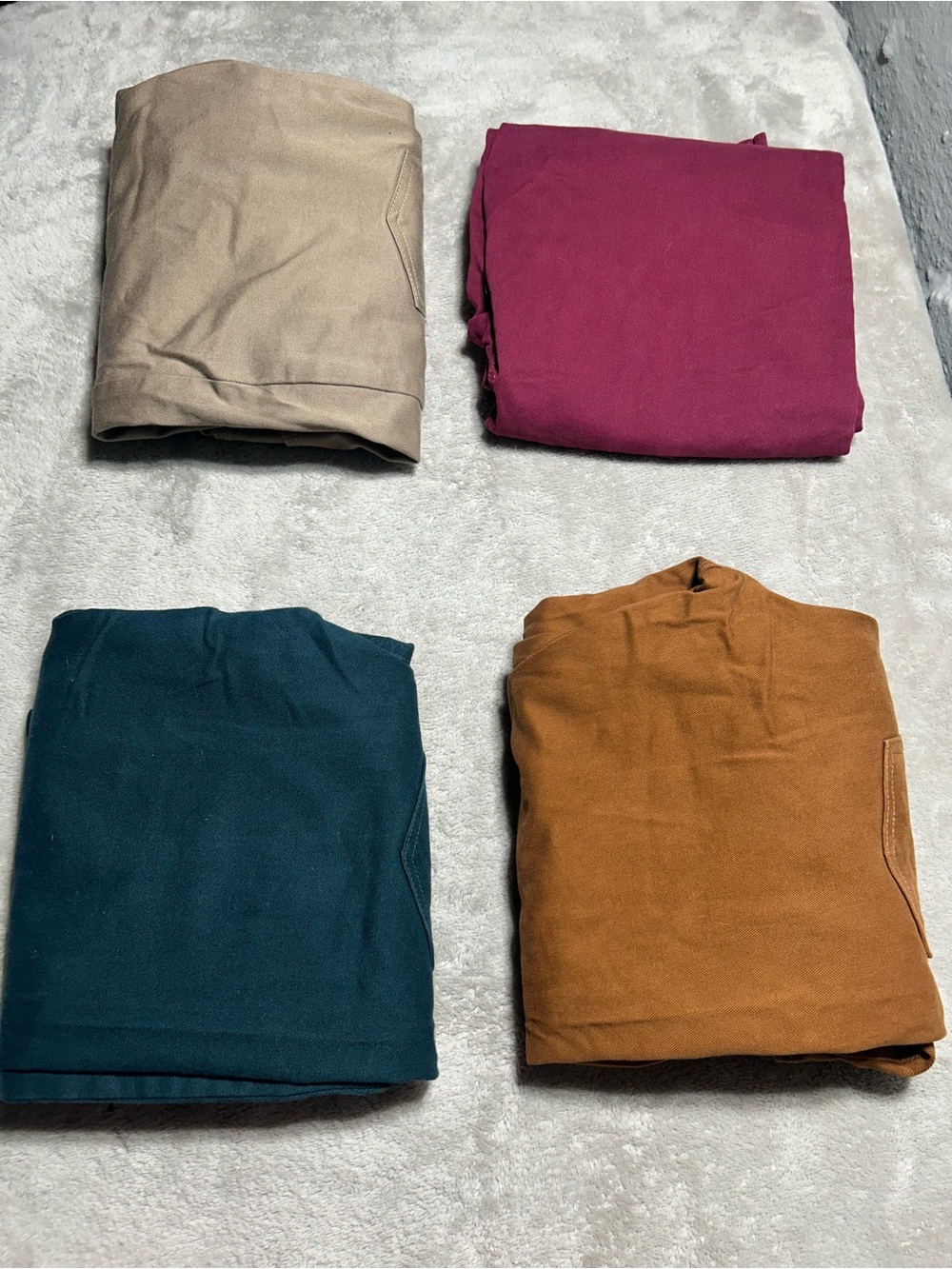 Set of Four Folded Gloria Vanderbilt Jeans in Neutral, Teal, Burgundy, and Rust